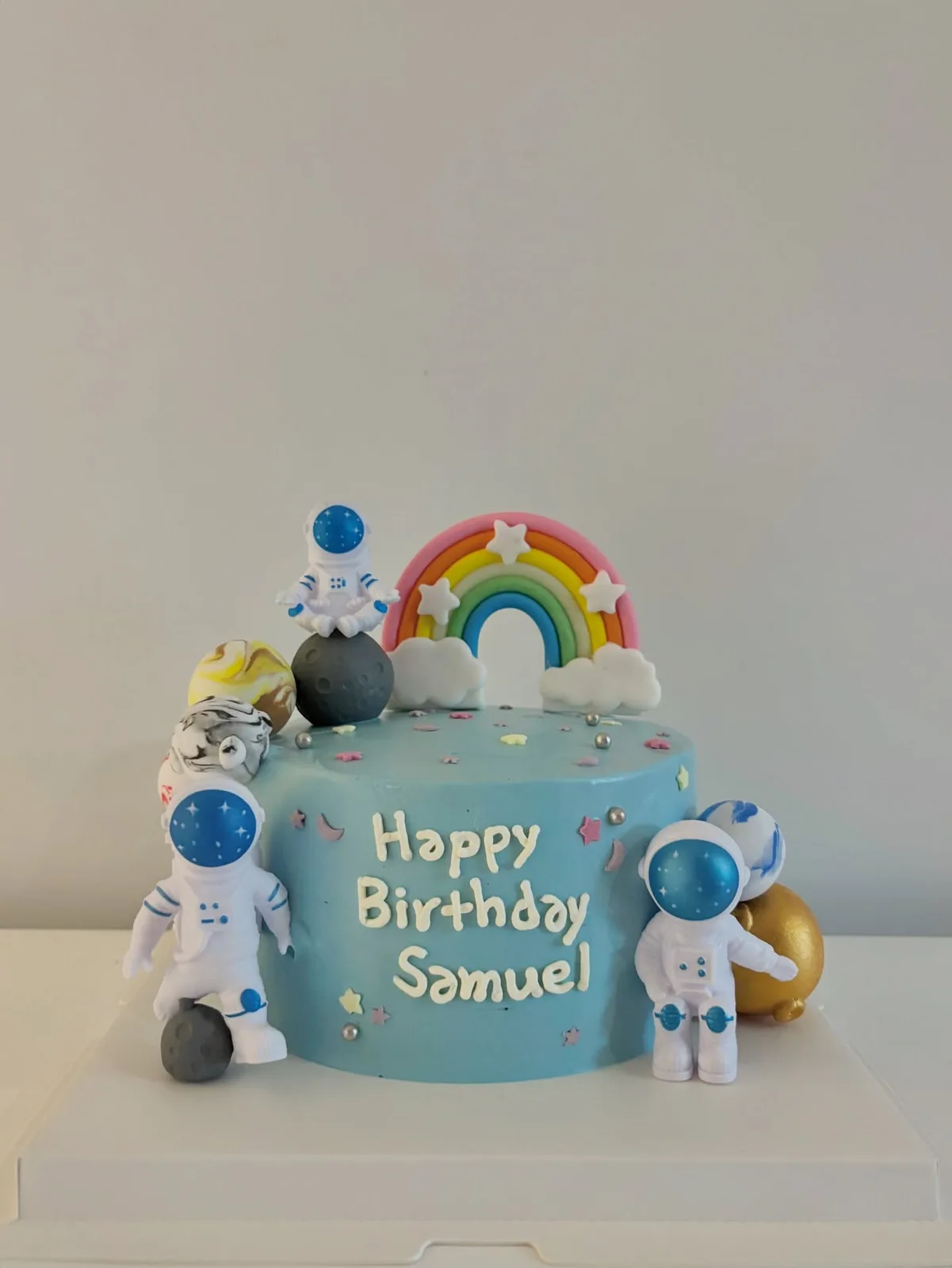 Blue cake with rainbow, astronaut and planet toppers, custom cake made in Streatham SW16 - Danine Cakes