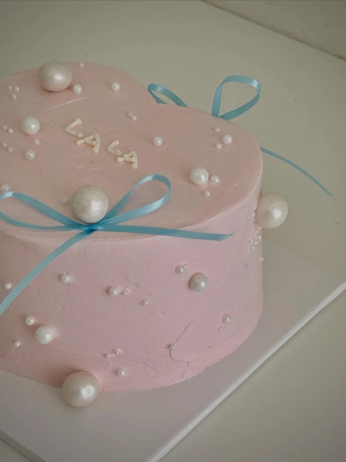 Blush pink cake with pearls and blue ribbon, Korean-inspired custom cake handmade in Streatham, London