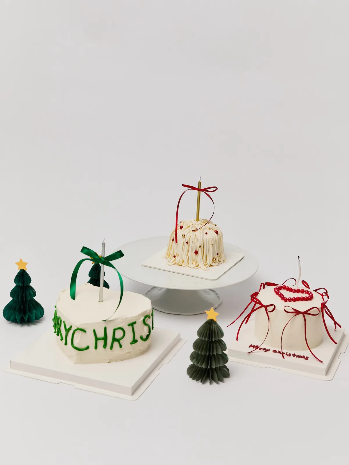 Christmas cake set with piped trees and red ribbon, custom cake made in Streatham SW16 - Danine Cakes