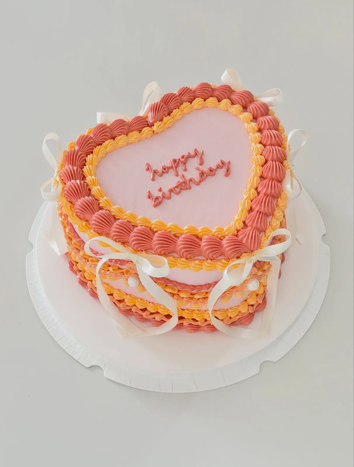 Coral and pink heart cake with piped border, custom cake made in Streatham SW16 - Danine Cakes