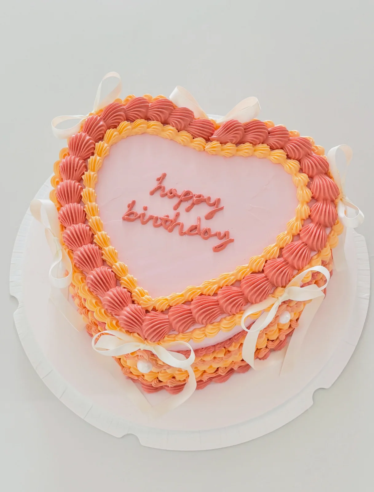Coral and pink heart cake with piped borders, custom cake made in Streatham SW16 - Danine Cakes