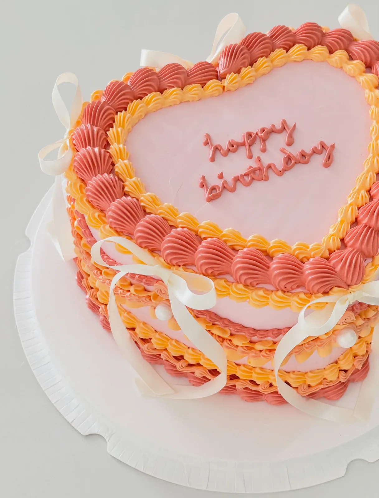 Coral and pink heart cake with piped borders, Korean-inspired custom cake handmade in Streatham, London