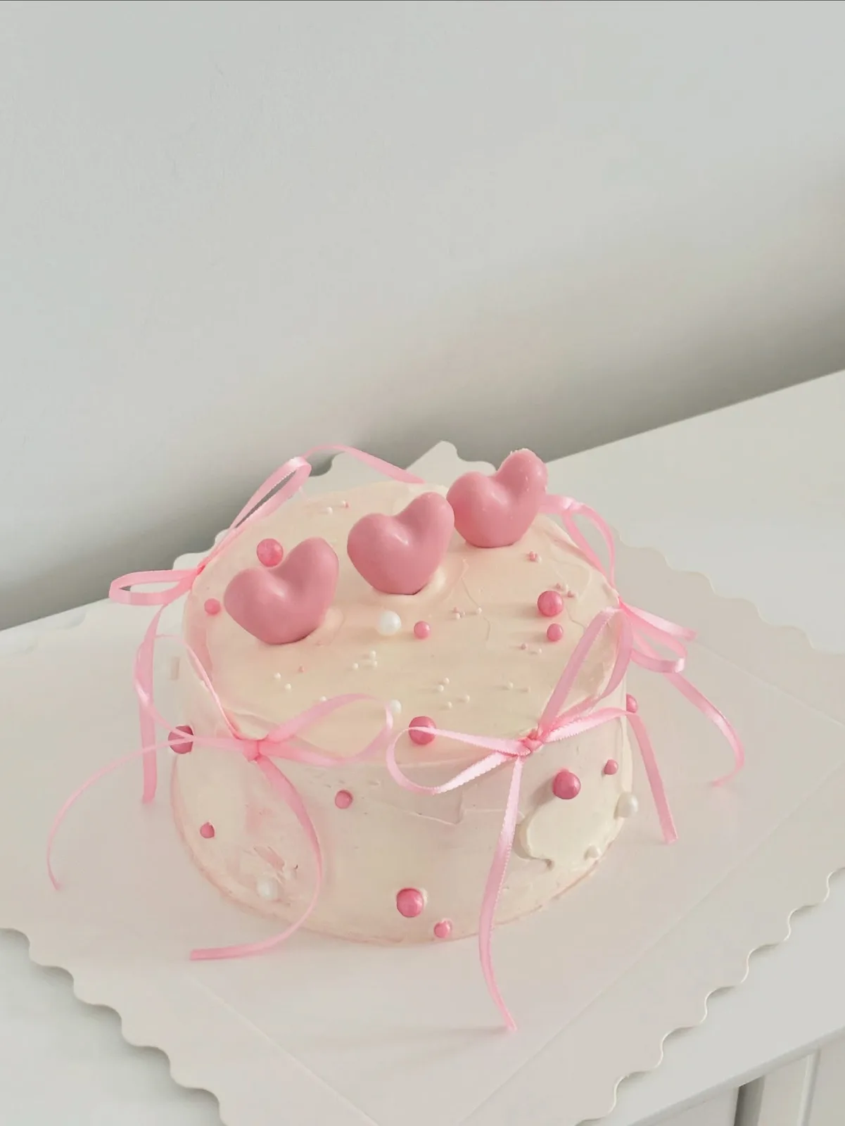 Cream cake with pink hearts, pearls and ribbons, custom cake made in Streatham SW16 - Danine Cakes