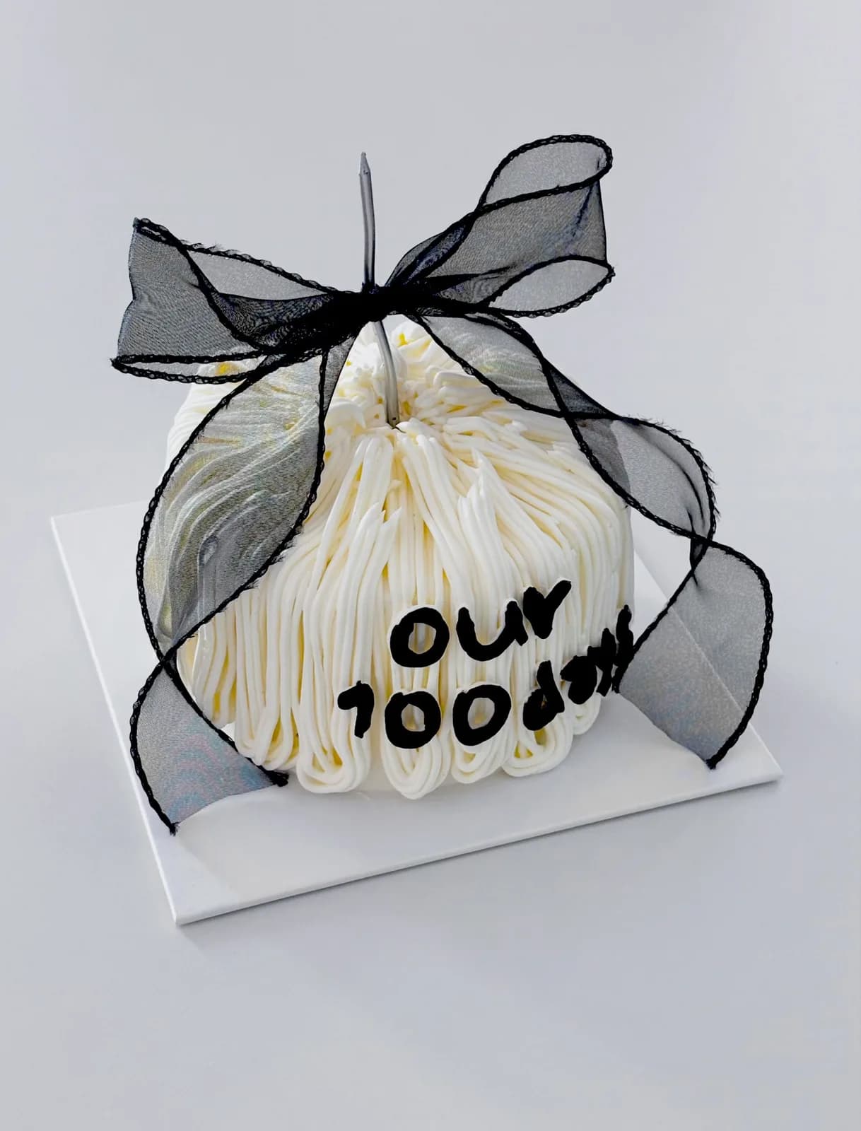 Cream piped dome cake with black organza bow, Korean-inspired custom cake handmade in Streatham, London