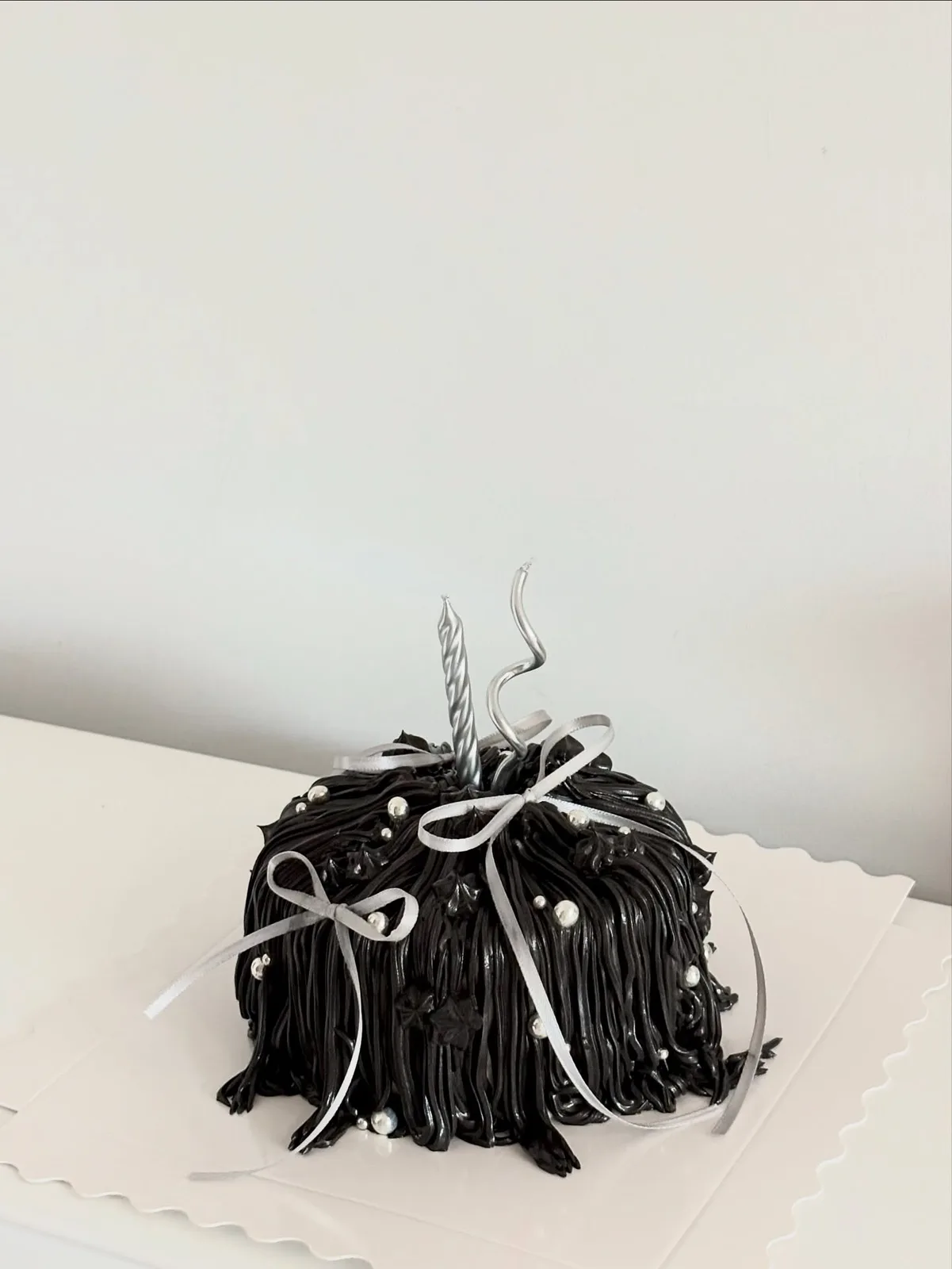 Dark chocolate piped strand cake with white ribbon, bespoke celebration cake from Danine Cakes, South London