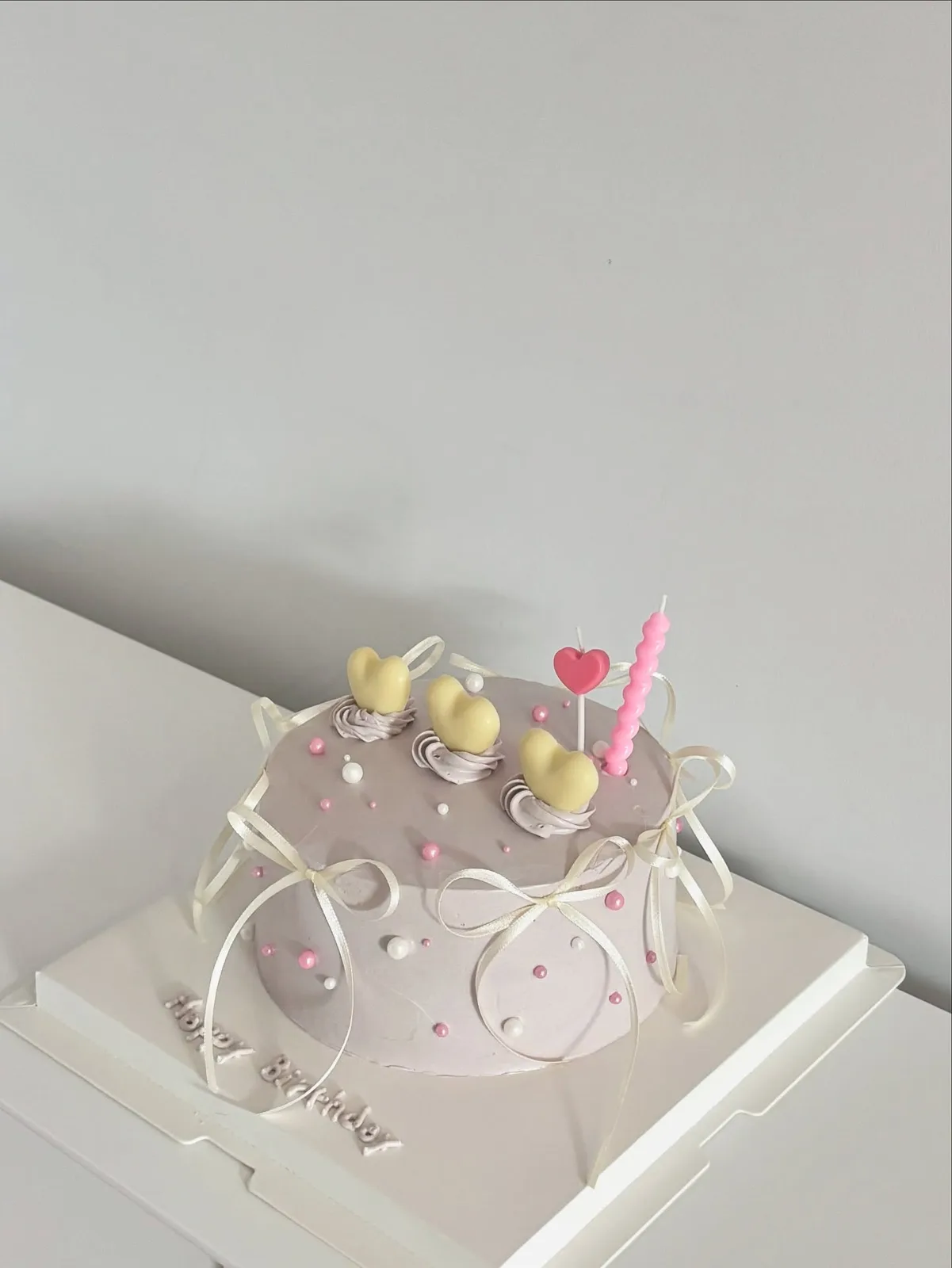 Grey cake with pastel dots, pearls and a candle, custom cake made in Streatham SW16 - Danine Cakes