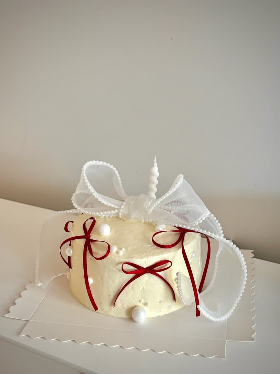 Ivory with crimson ribbon bows & pearl drops