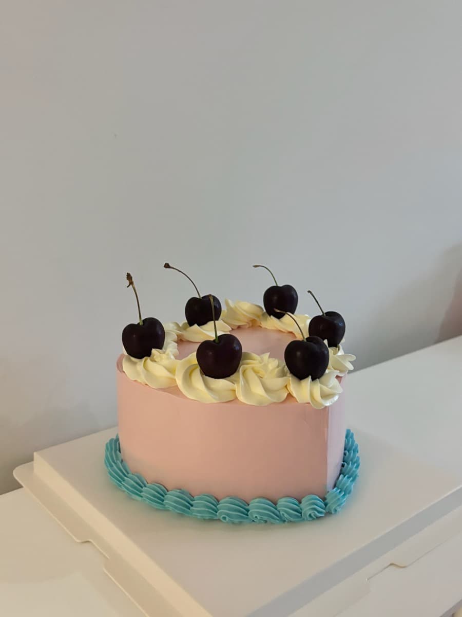 Fresh dark cherries on a blush pink base