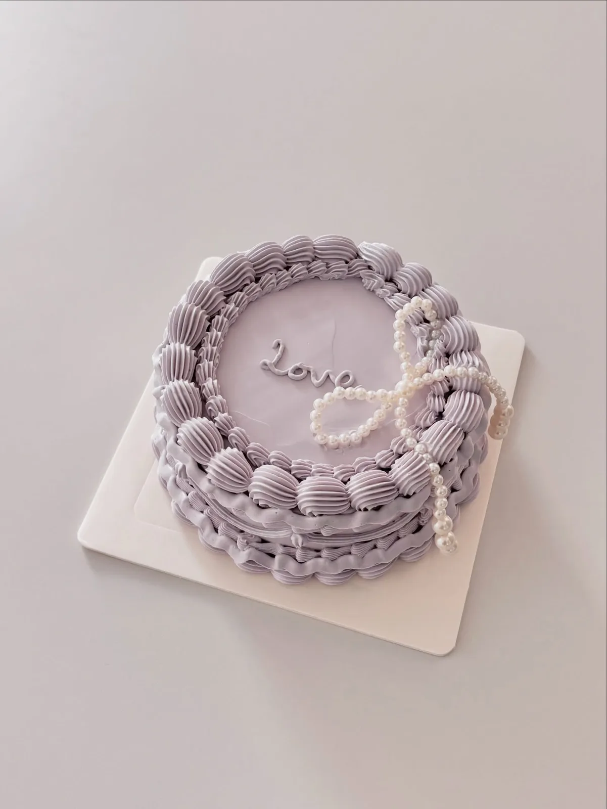 Lilac cake with pearls and piped Love lettering, custom cake made in Streatham SW16 - Danine Cakes