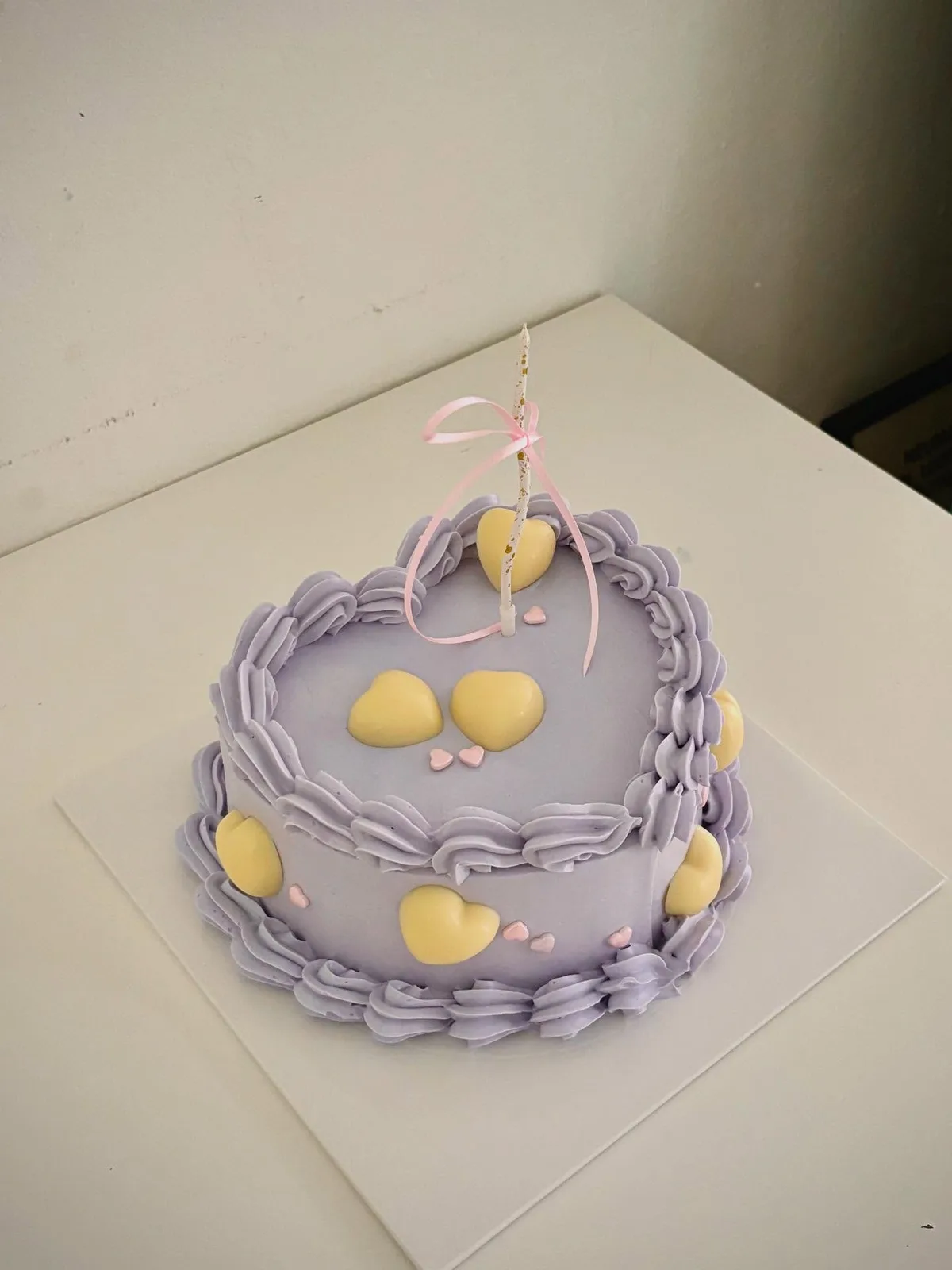 Lilac cake with yellow hearts and piped border, handmade to order by Danine Cakes in Streatham, South London