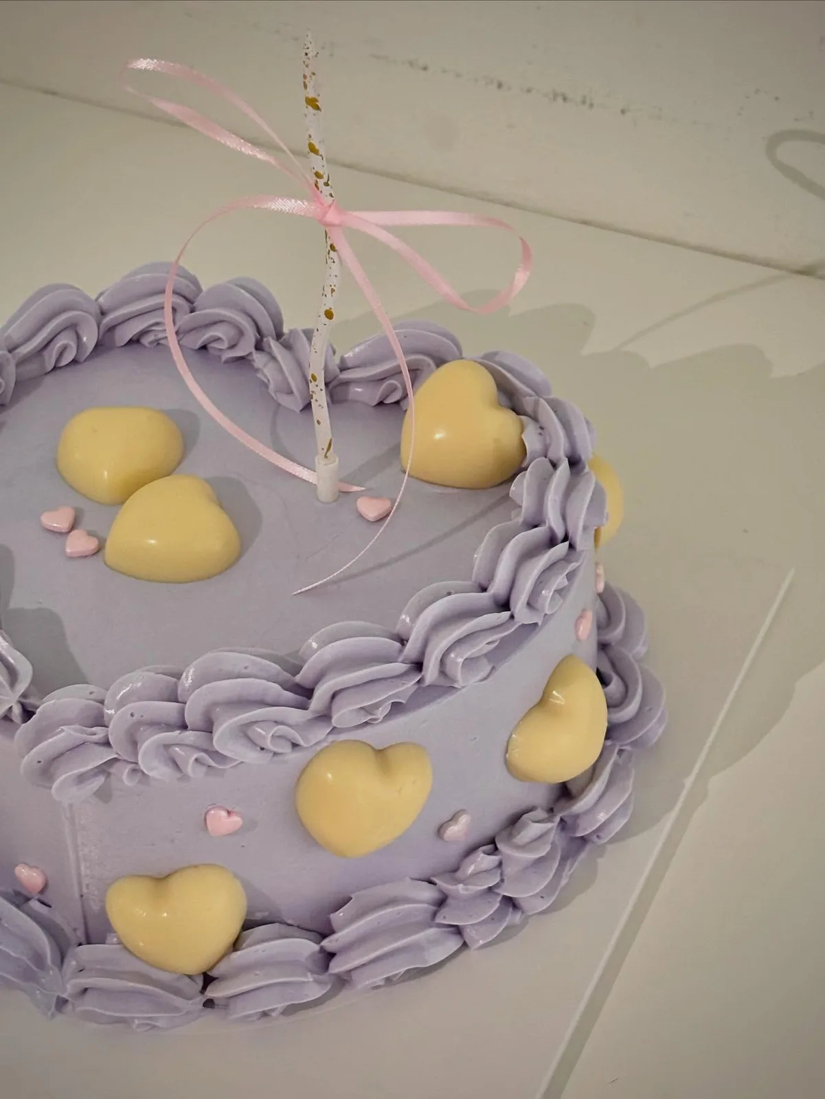 Lilac cake with yellow hearts and piped shell border, handmade to order by Danine Cakes in Streatham, South London