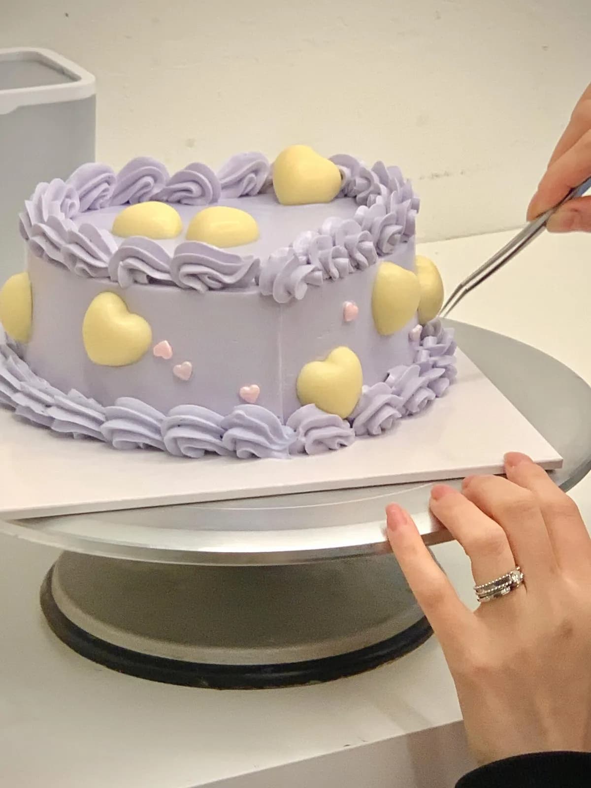 Lilac cake with yellow hearts and piped shell border, handmade to order by Danine Cakes in Streatham, South London