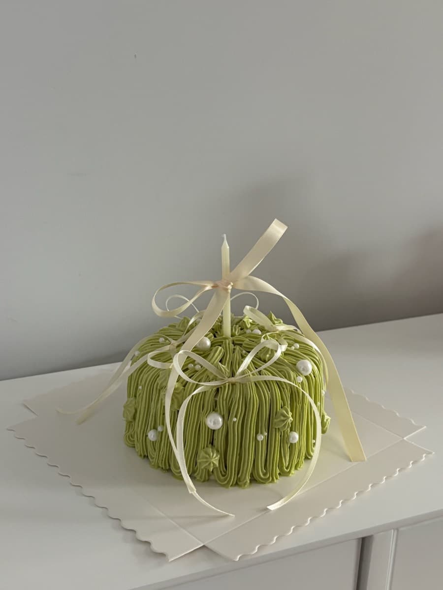 Matcha green dome with cream ribbons