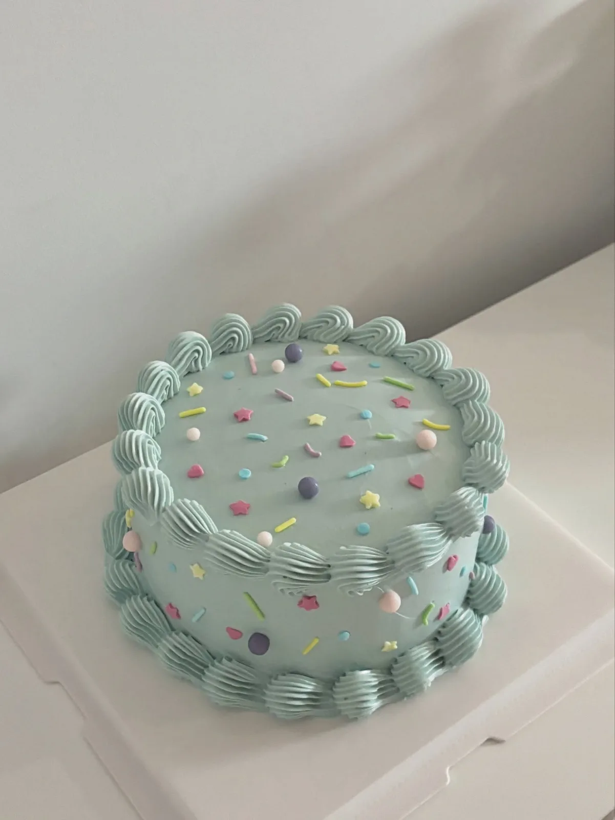 Mint cake with pastel confetti and piped border, handmade to order by Danine Cakes in Streatham, South London