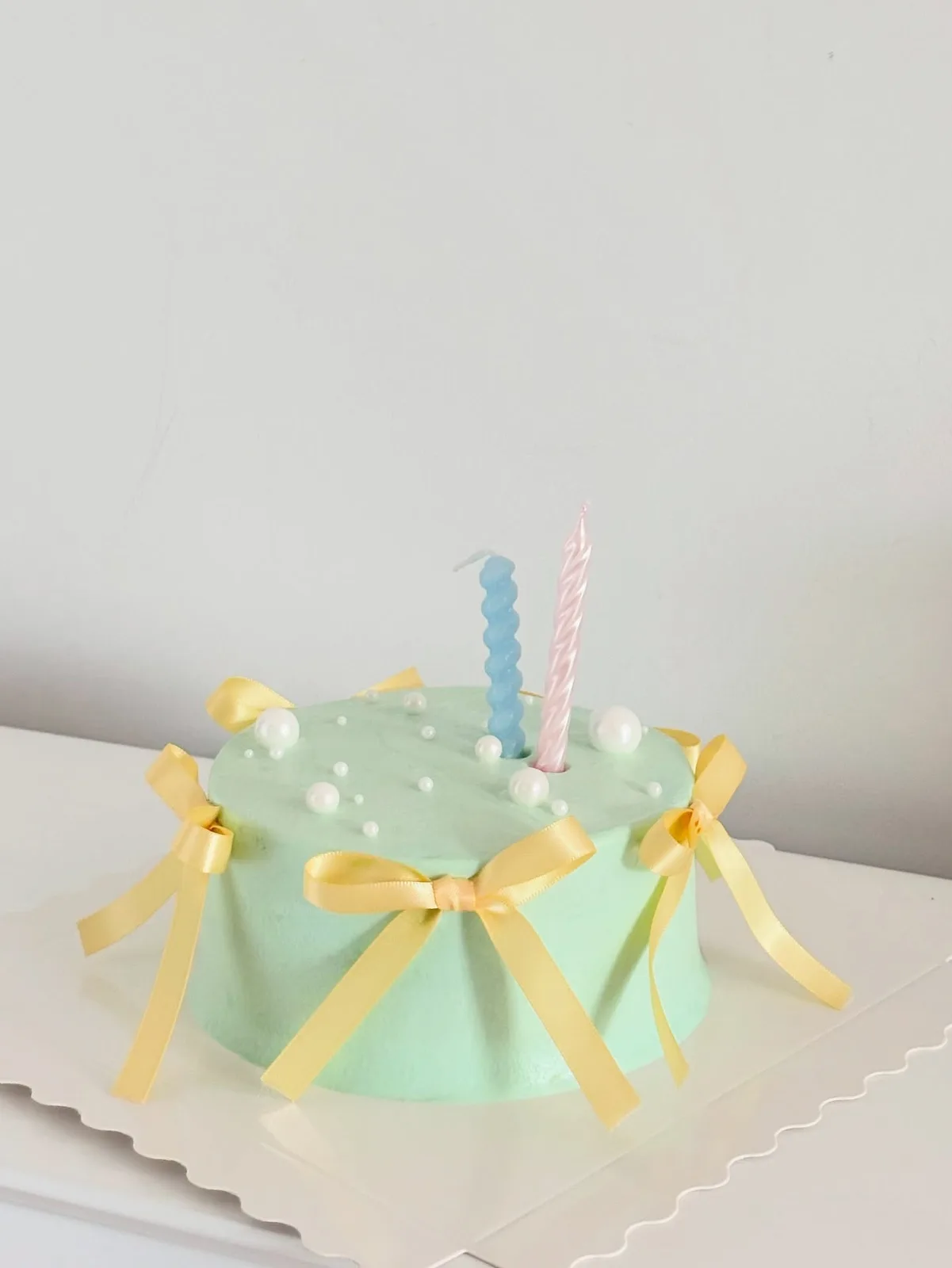 Mint cake with yellow bows and candle, Korean-inspired custom cake handmade in Streatham, London