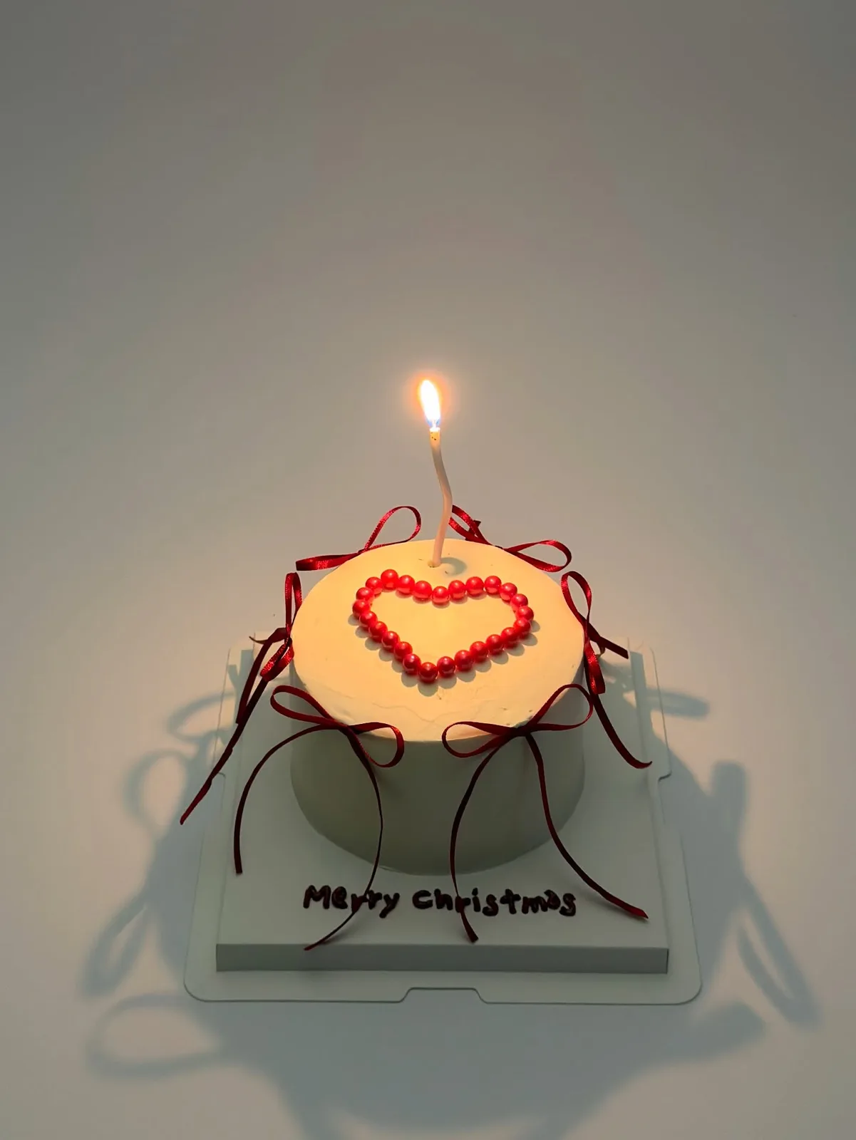 Orange cake with piped red heart and candle, Korean-inspired custom cake handmade in Streatham, London