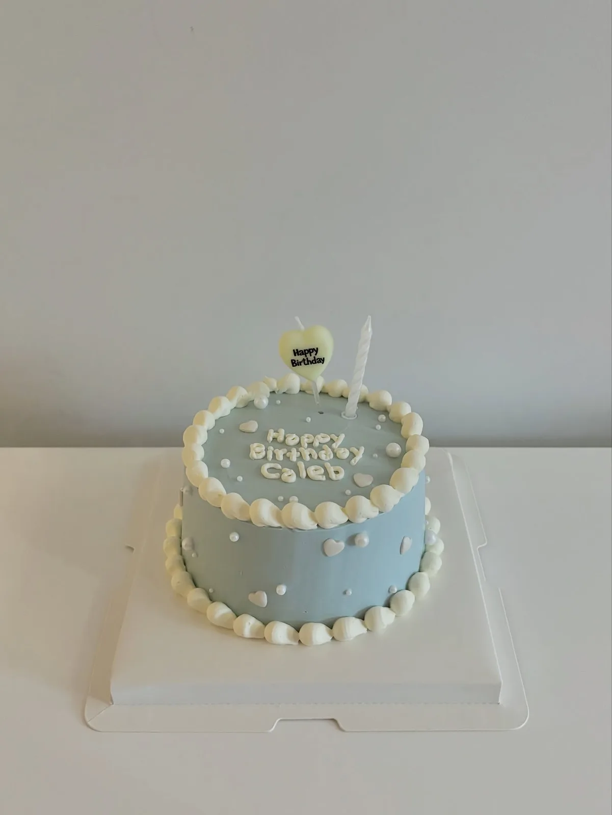 Pale blue cake with white dots and piped border, Korean-inspired custom cake handmade in Streatham, London