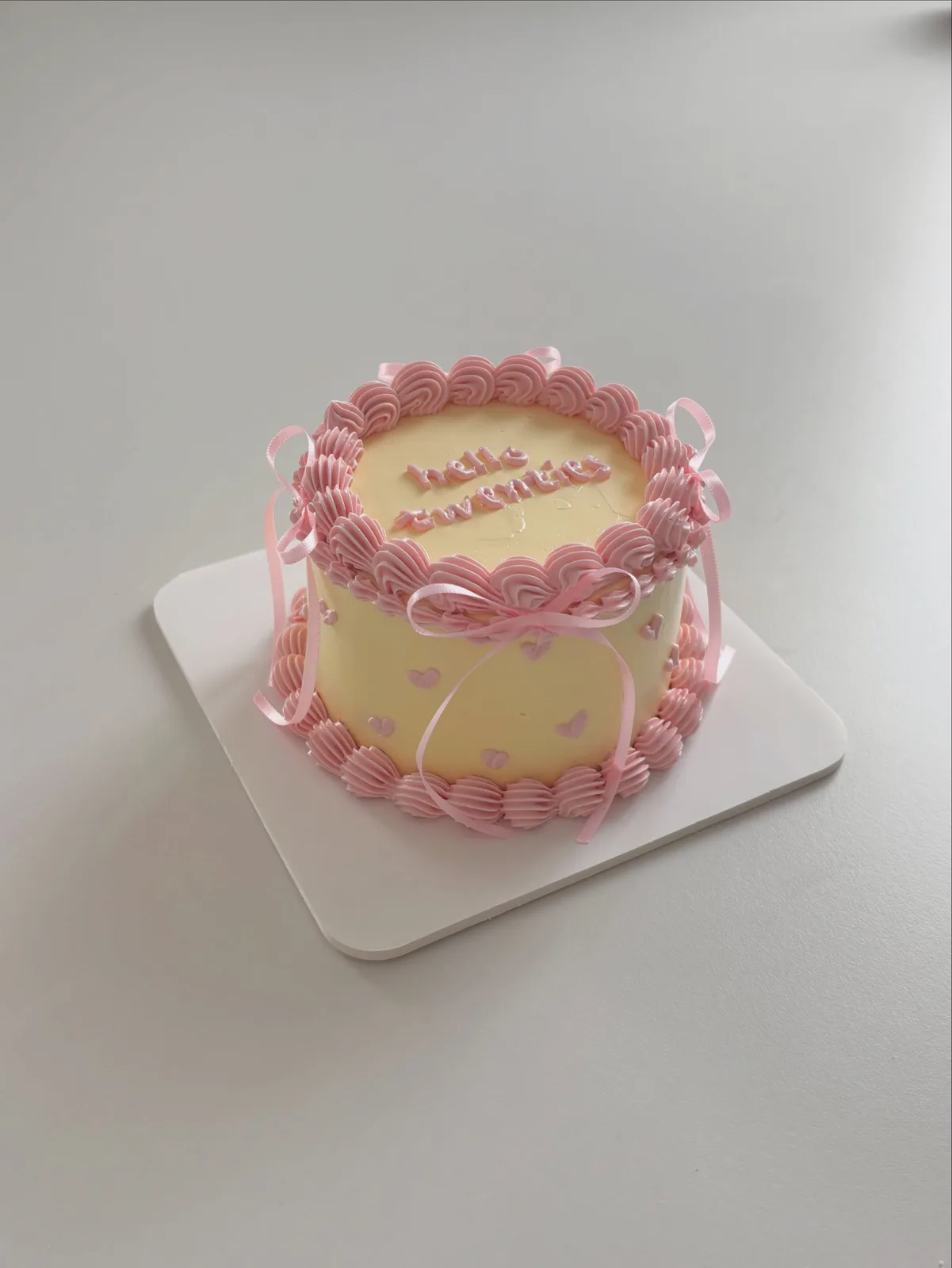 Pale yellow cake with pink piped border and lettering, custom cake made in Streatham SW16 - Danine Cakes