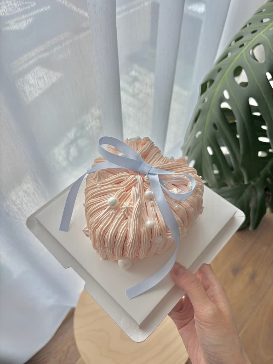 Peach fluffy dome with a sky blue bow