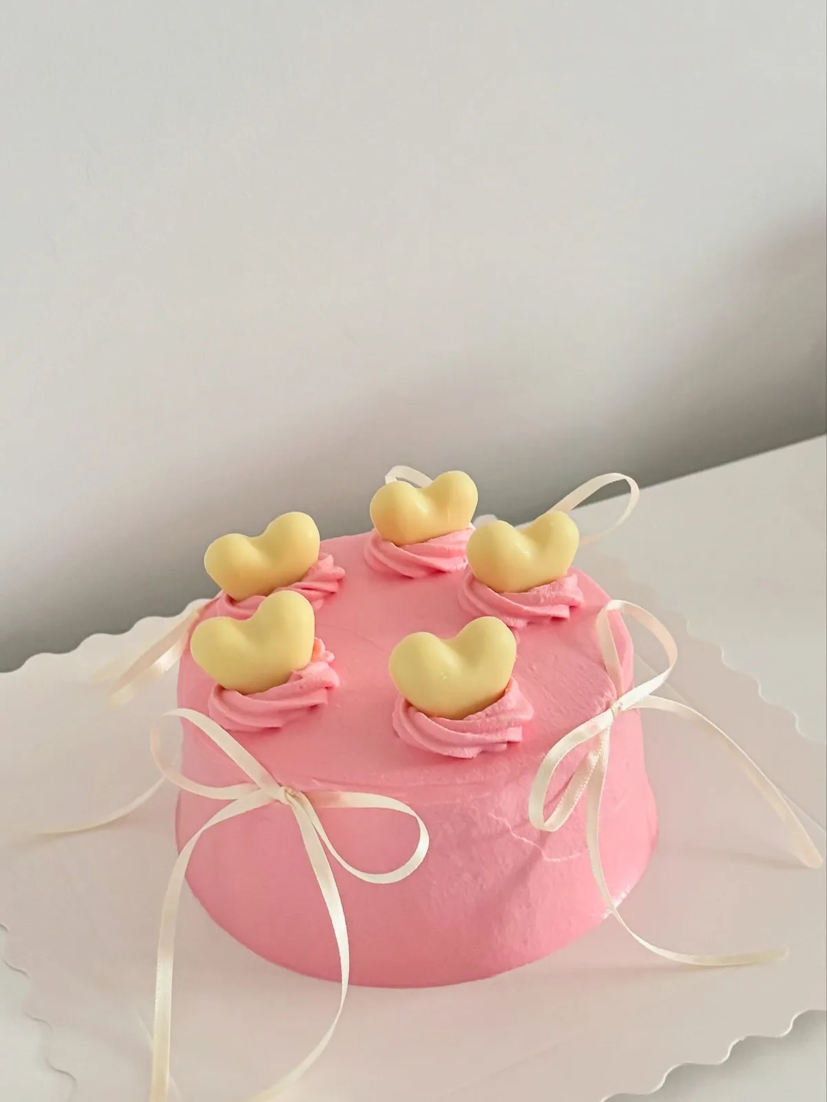 Pink cake with yellow hearts and satin ribbons, Korean-inspired custom cake handmade in Streatham, London