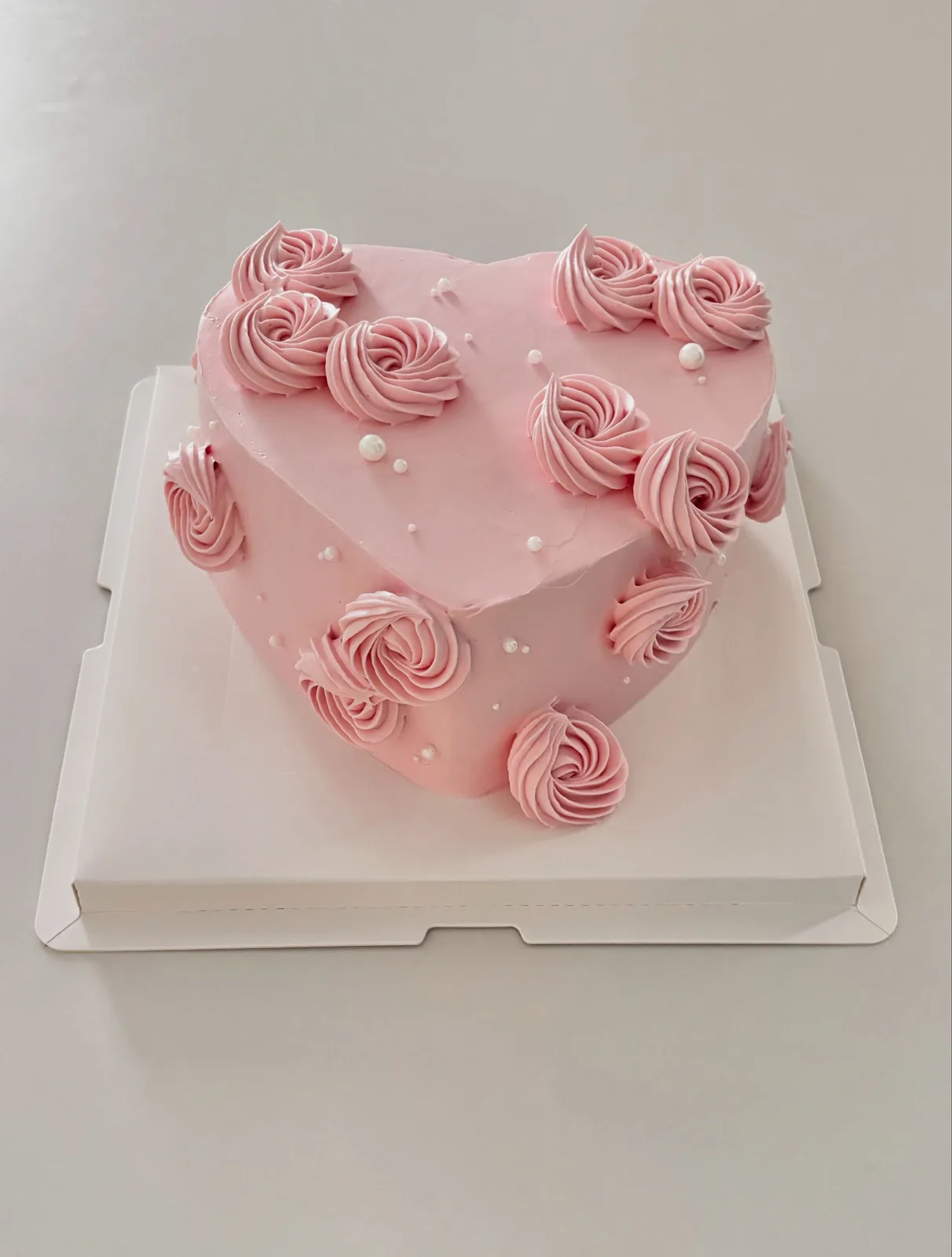Pink heart cake with buttercream rosettes and pearls, bespoke celebration cake from Danine Cakes, South London