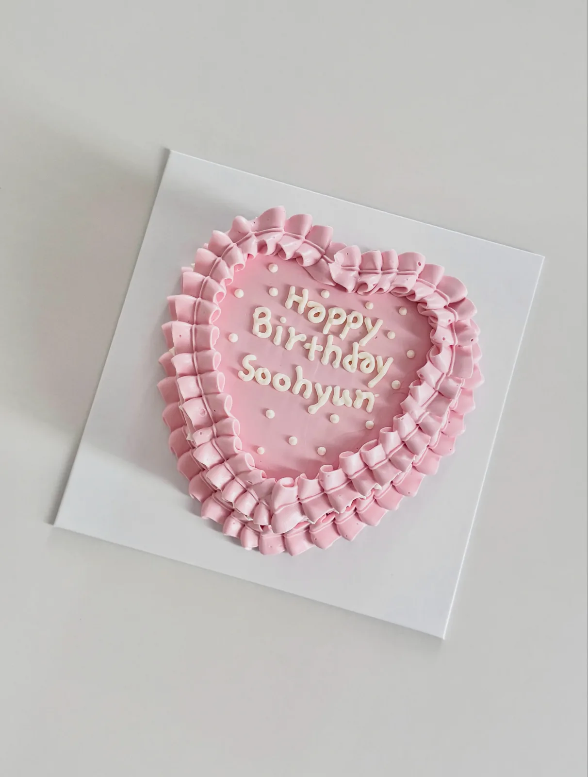 Pink heart cake with ruffle border and lettering, handmade to order by Danine Cakes in Streatham, South London