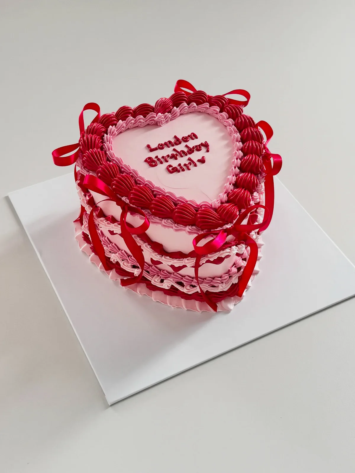 Red heart cake with ribbon and piped lace border, Korean-inspired custom cake handmade in Streatham, London