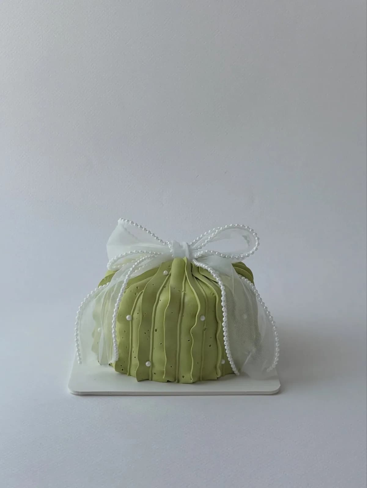 Sage green piped dome cake with pearl trim, Korean-inspired custom cake handmade in Streatham, London