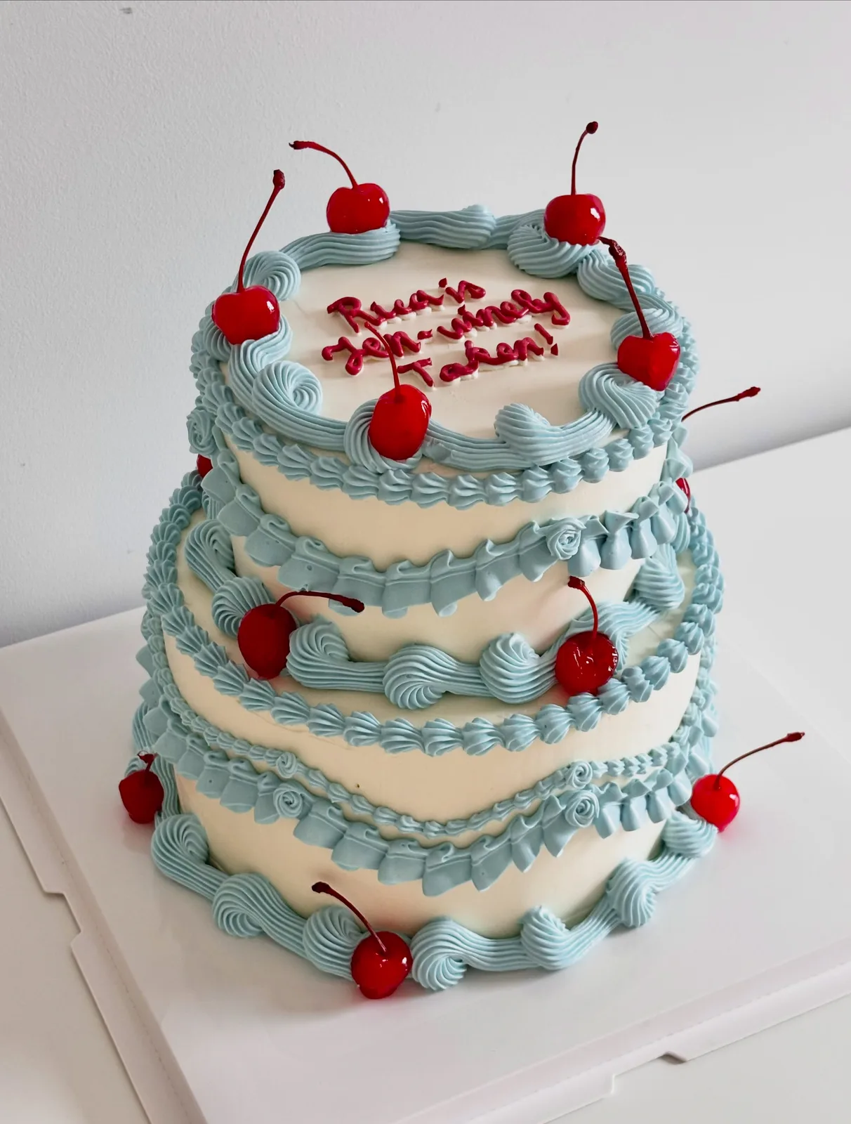 Three tier blue cake with glace cherries and piped shells, Korean-inspired custom cake handmade in Streatham, London