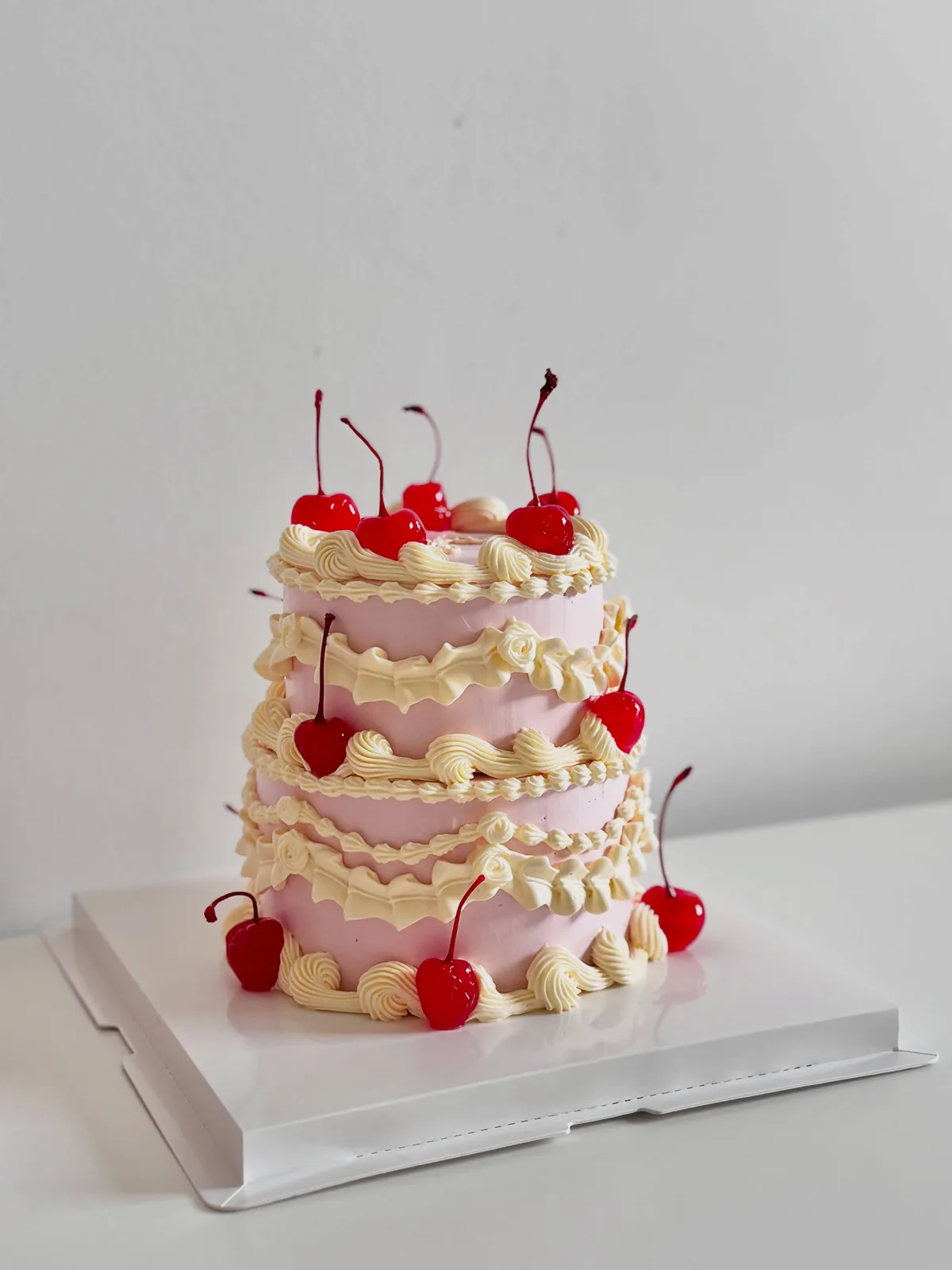 Three tier pink and cream cake with cherries, custom cake made in Streatham SW16 - Danine Cakes