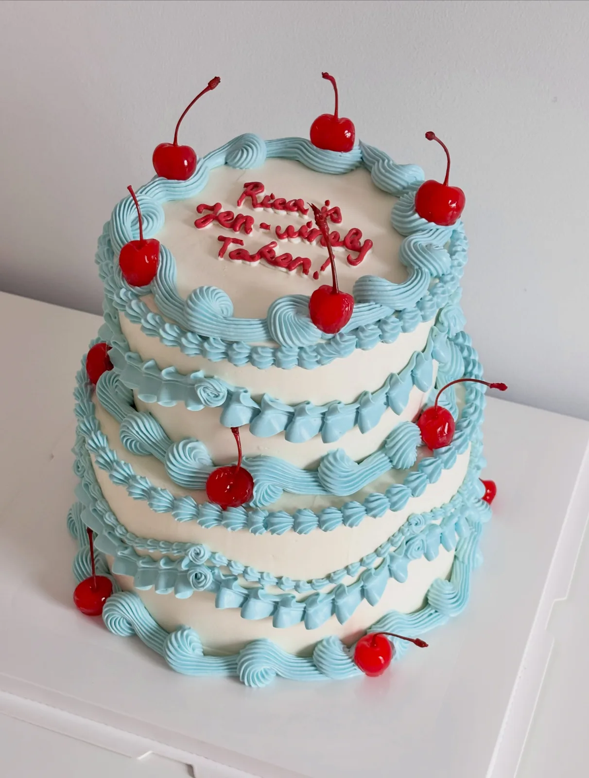 Two tier blue and white cake with glace cherries, bespoke celebration cake from Danine Cakes, South London