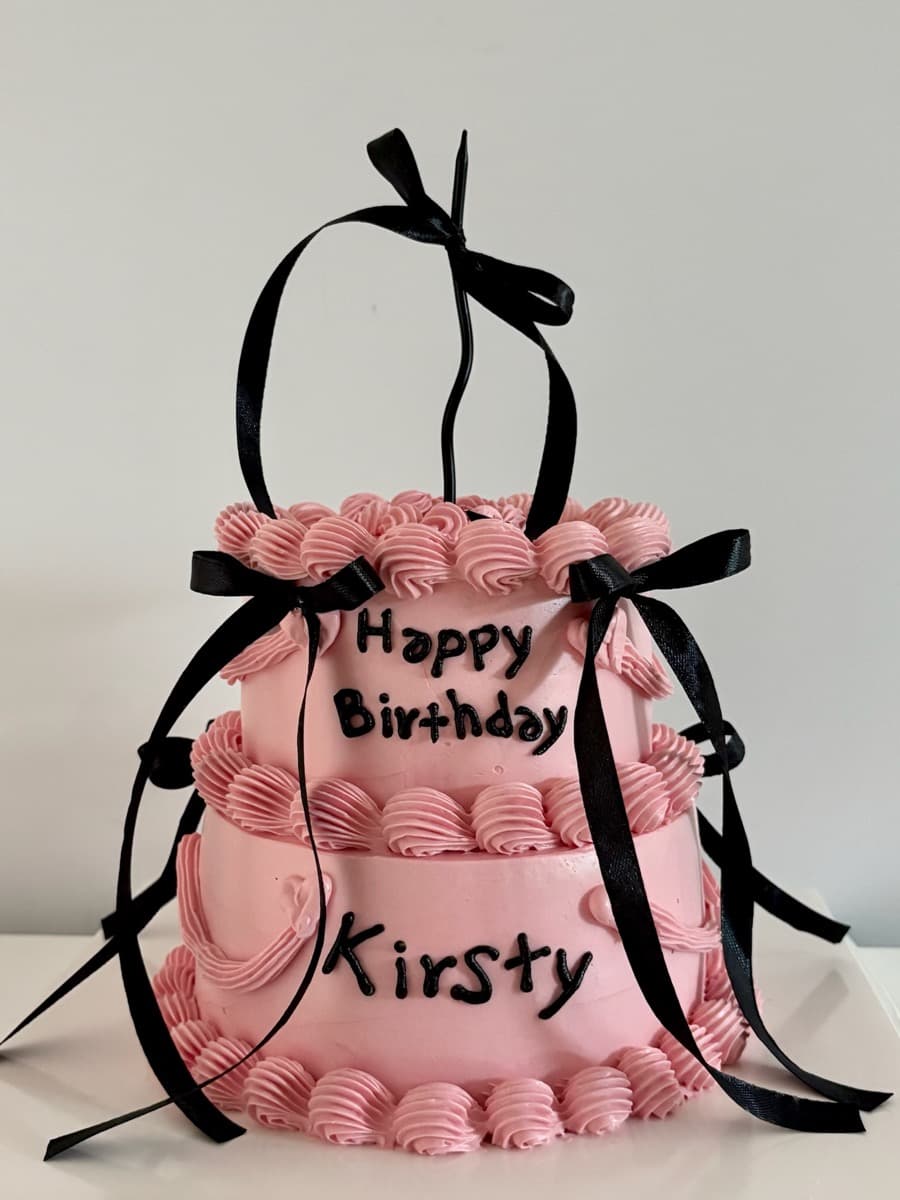 Two tiers of pink with bold black bows