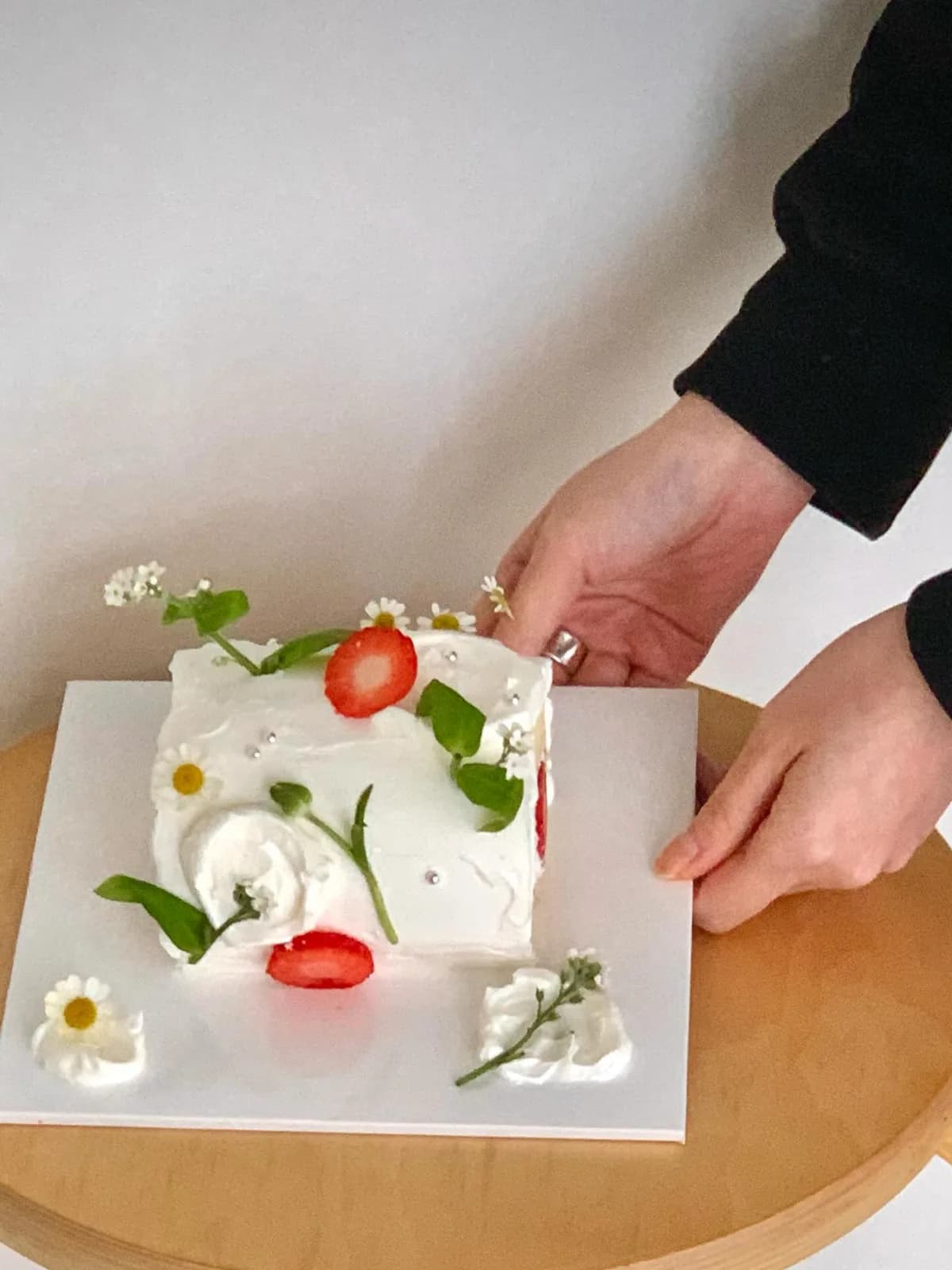 White cream cake with strawberries and fresh flowers, Korean-inspired custom cake handmade in Streatham, London